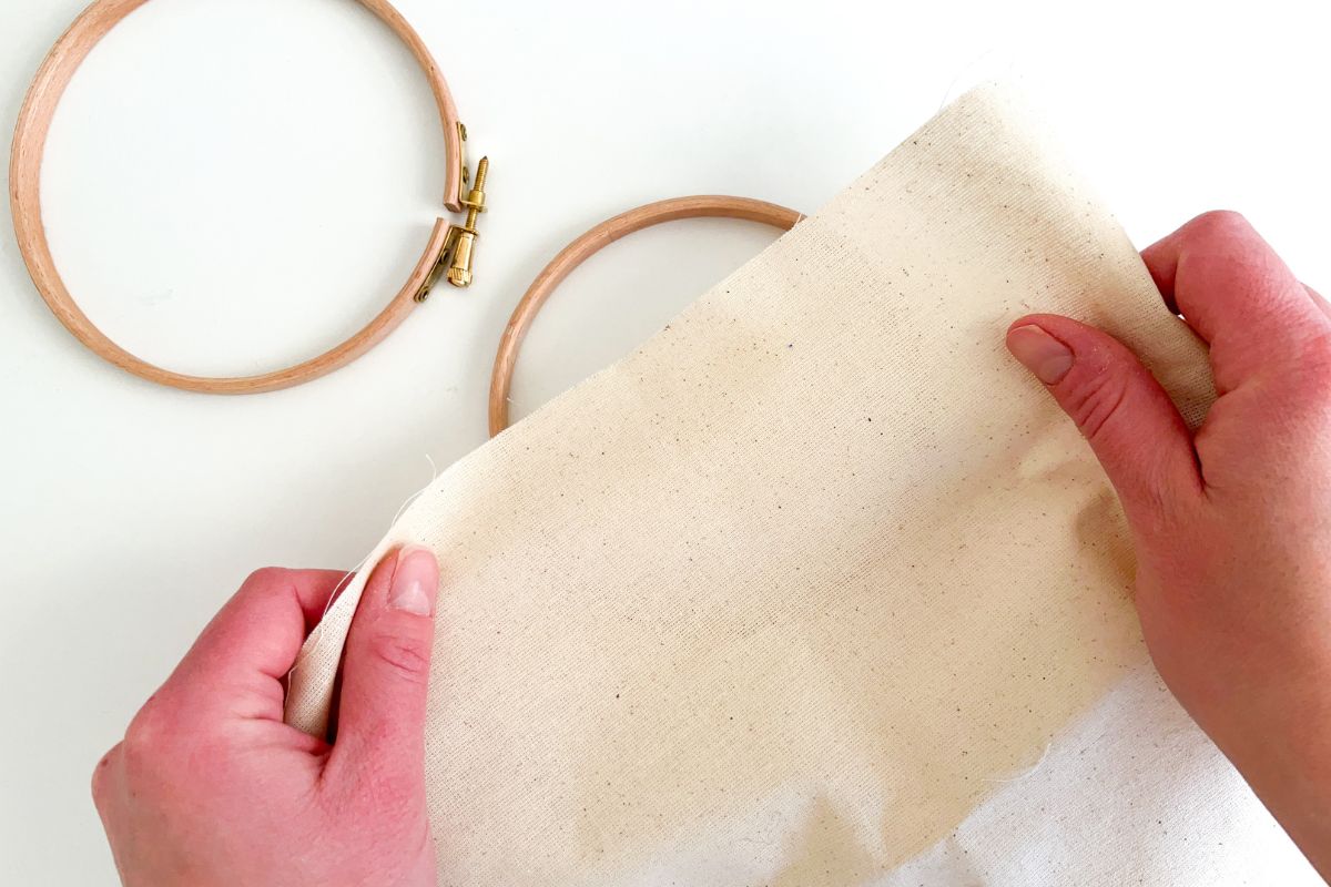 placing fabric in embroidery hoop for hand sewing projects