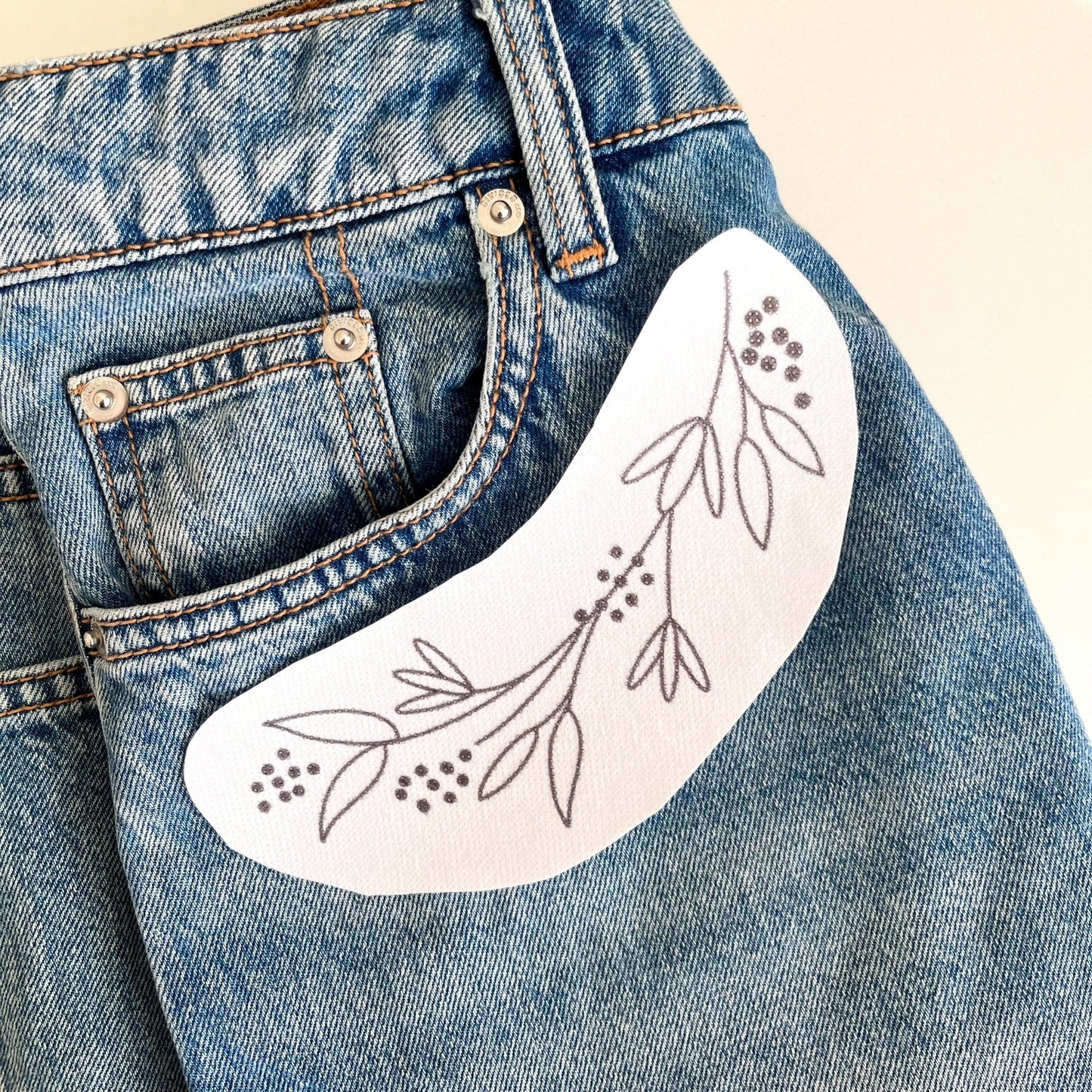 Floral hand embroidery design for front of jeans pocket.