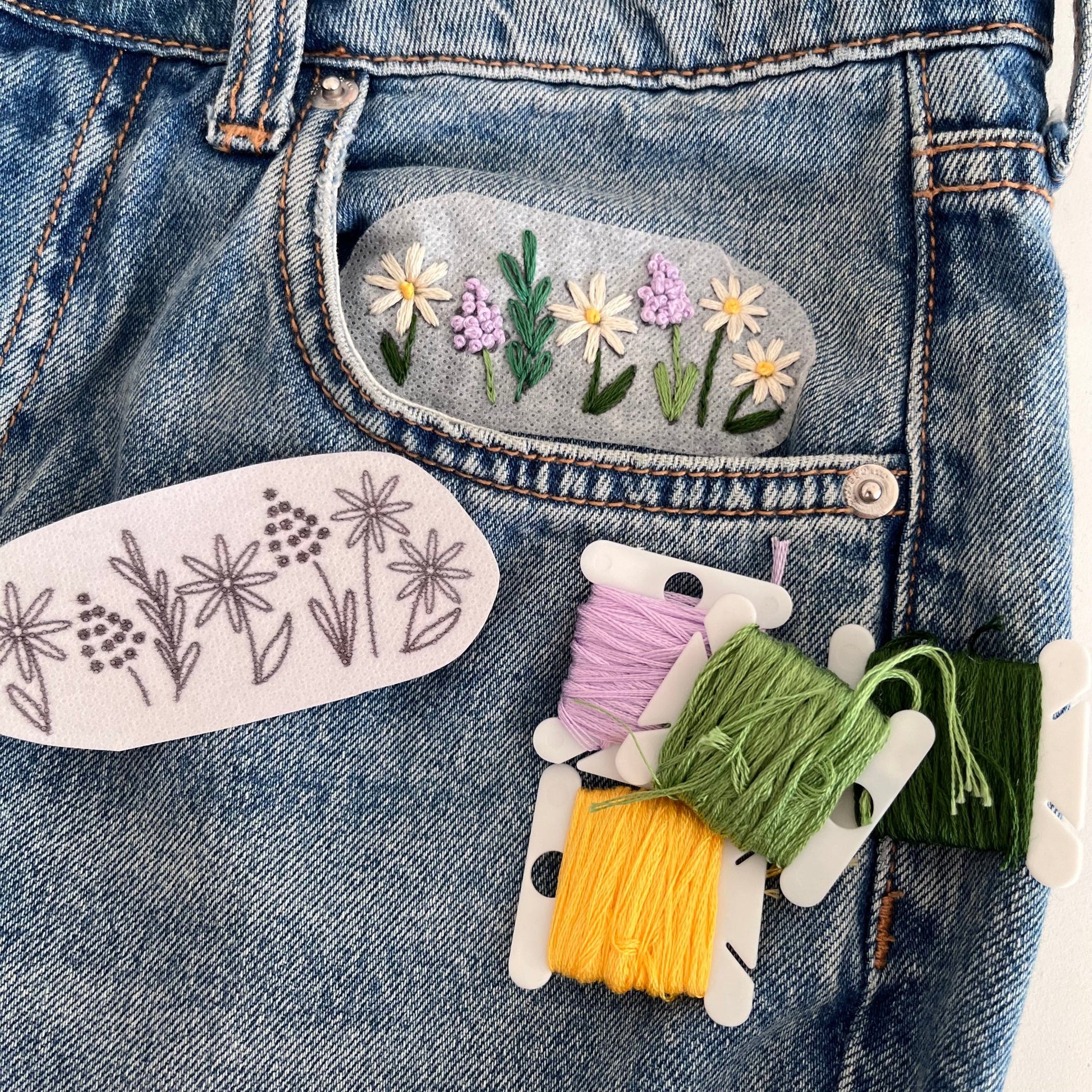 Floral Design stitched onto jeans pocket using wash away embroidery patches