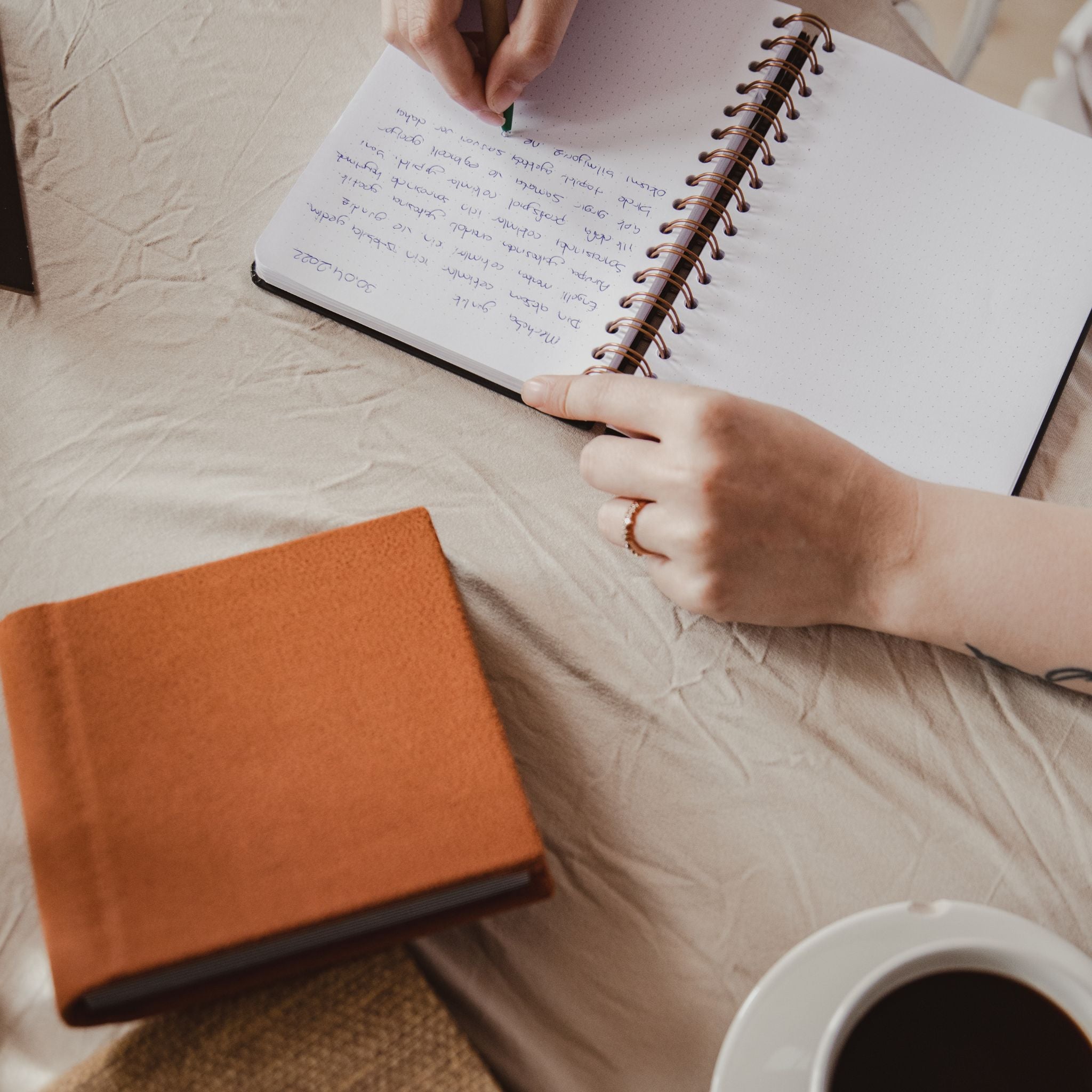 Someone writing by hand in a diary